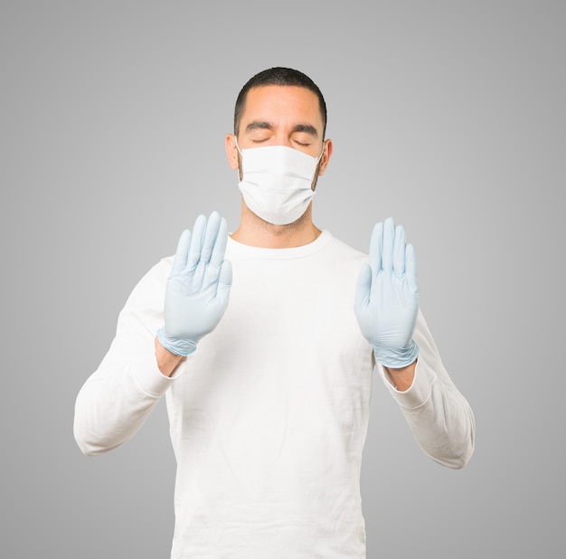 Young male doctor wearing mask and protective gloves