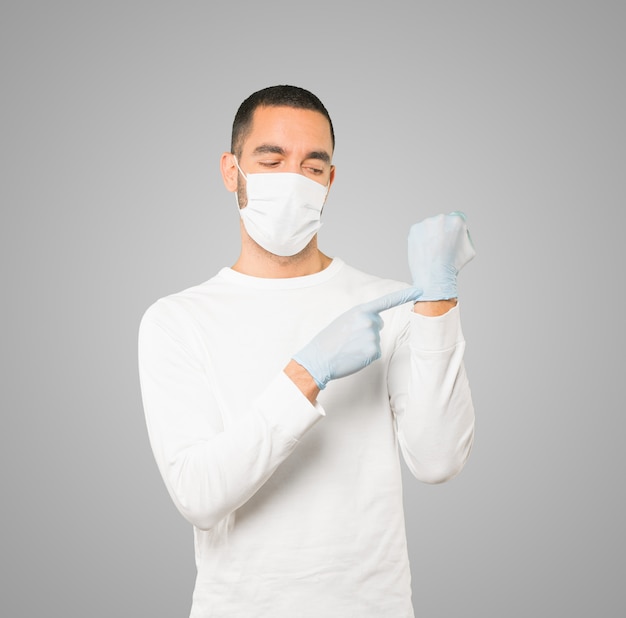 Young male doctor wearing mask and protective gloves