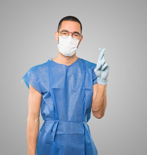 Young male doctor wearing mask and protective gloves