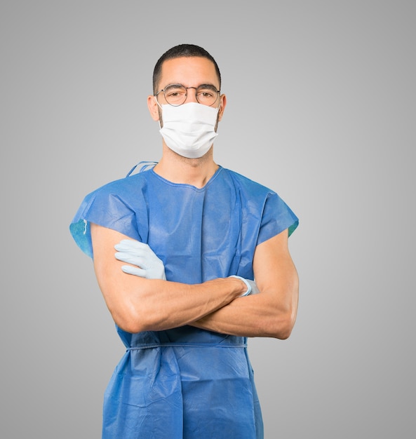 Young male doctor wearing mask and protective gloves