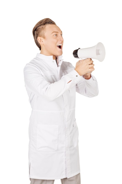 Young male doctor in white coat speaking into megaphone People and medicine concept Image isolated on a white background