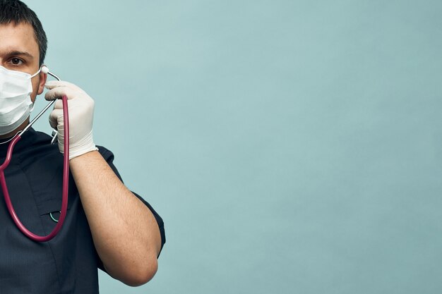 A young male doctor with protective gloves and a stethoscope