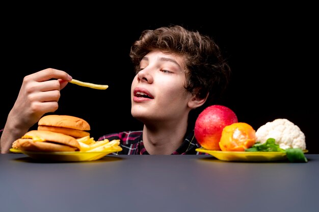 Young male eat fried potato free with soda bb