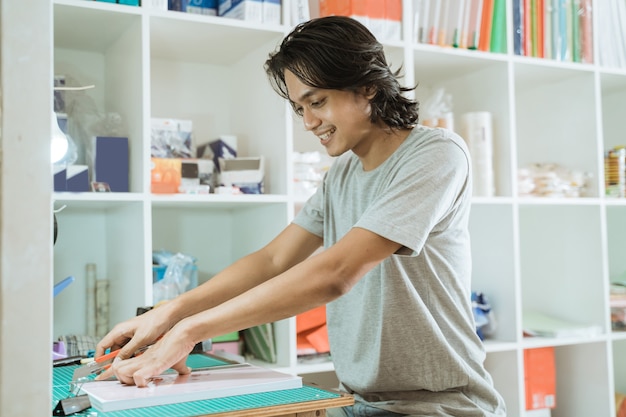 Young male entrepreneur working in a stationery shop