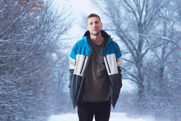 A young male guy wearing warm winter season jacket on a cold day