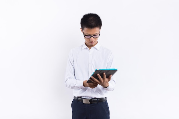 A young male holding a tablet in his hand