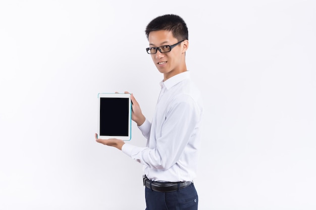 A young male holding a tablet in his hand