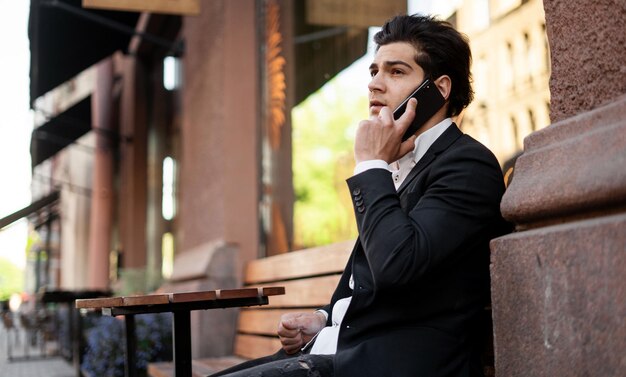 A young male manager uses a gadget The lawyer answers clients by phone