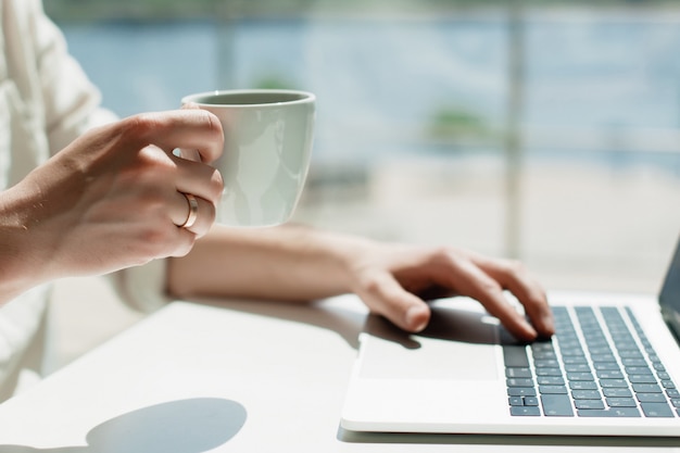 A young male millennial works remotely on a laptop. 