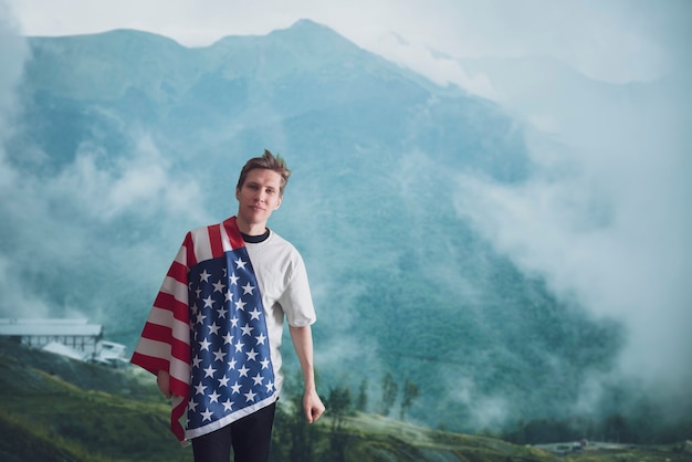 A young male patriot with a usa national flag outside independence th of july