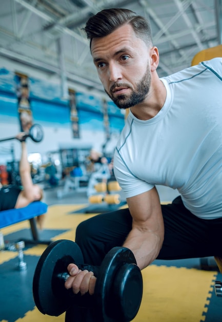 Young male performing TRX training at the gymhealthy lifestyle