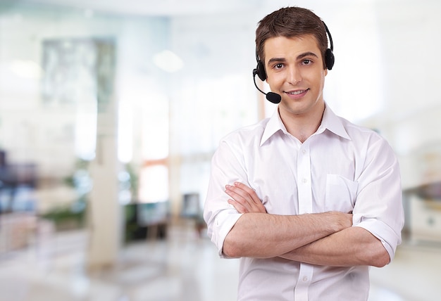 Young male phone service manager on blurred office background