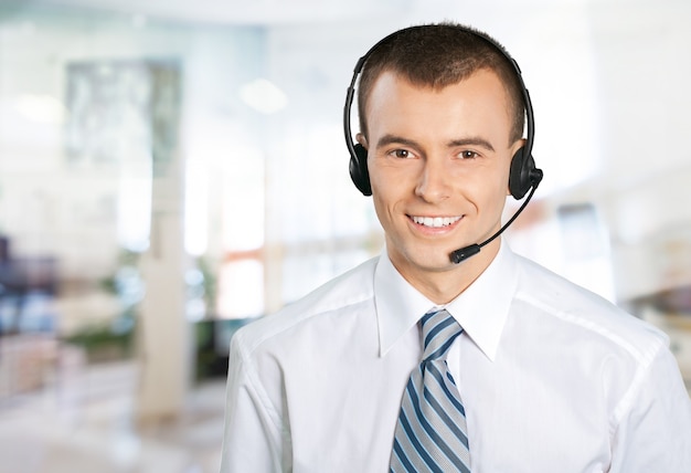 Young male phone service manager on blurred office background