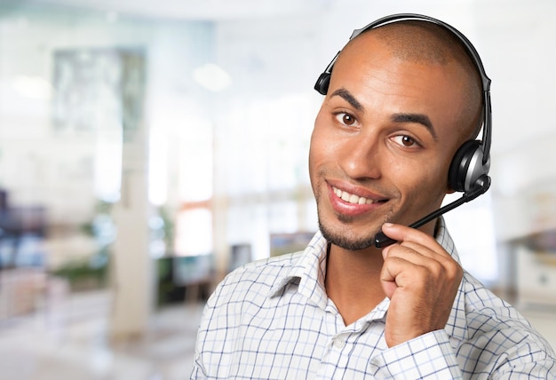 Young male phone service manager on blurred office background