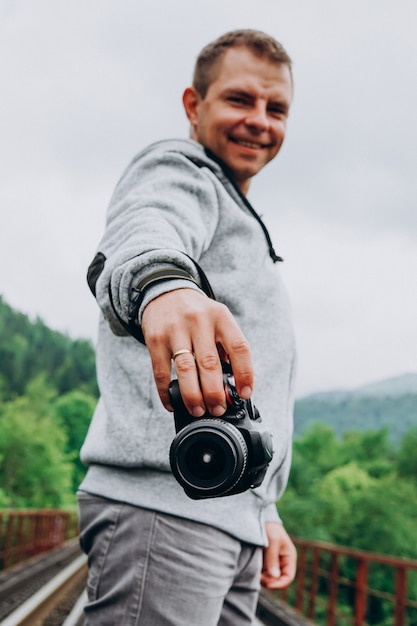 Young male photographer holding a camera