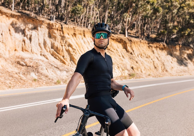 Young male professional cyclist relaxing after ride  person