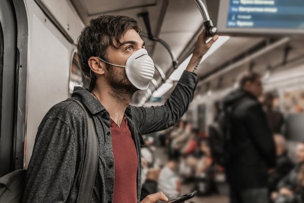 Photo young male in protective mask in subway train health awareness for protection