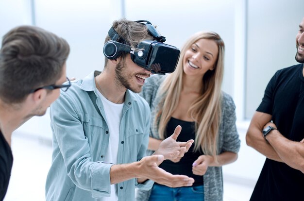 Young male software programmer testing a new app with 3d virtual reality glasses in office