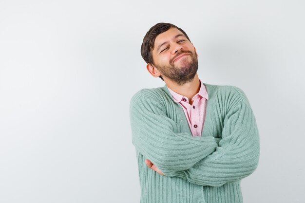 Free Photo Mature man pretending to show something in shirt