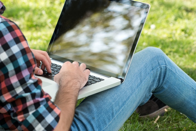 Young male student programmer work study outdoors