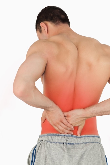 Young male suffering from back pain