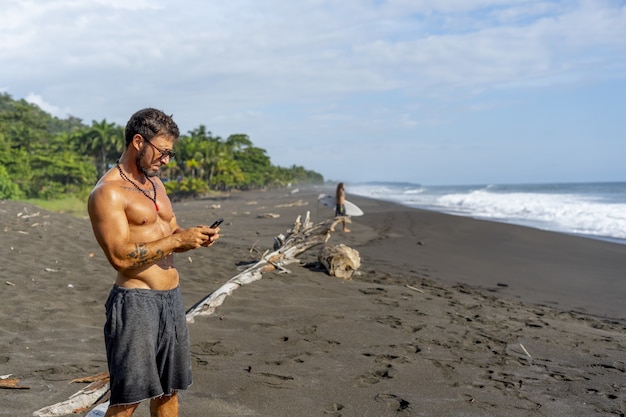 Young male taking a photo on the beach