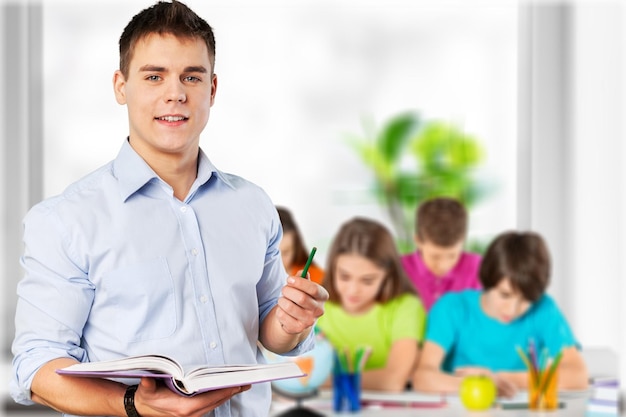 Young male teacher   standing in class