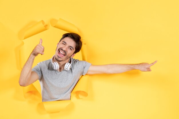 young male with headphones on a yellow isolated background music ultrasound audio