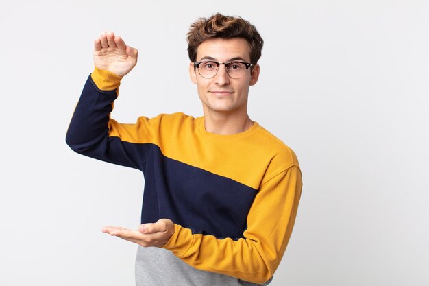 young man against flat color wall