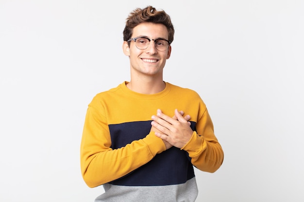 young man against flat color wall