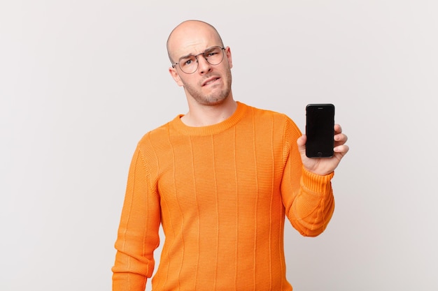 young man against flat color wall