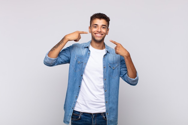 young man against isolated wall