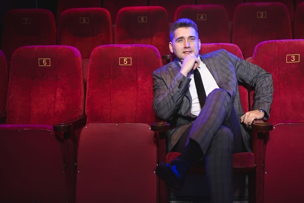 Young man alone in a movie theater