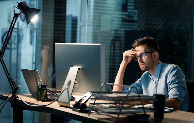 Young man alone working late