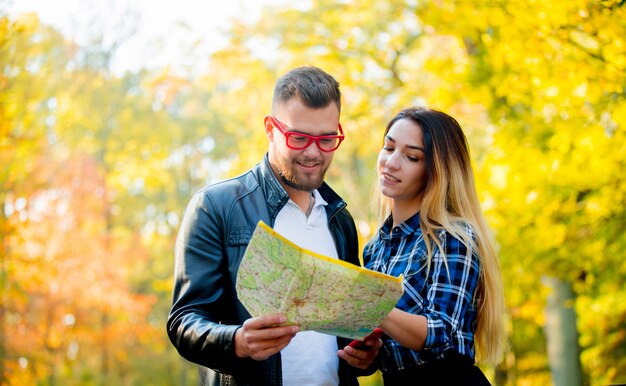 Young man asking for help in navigation a beautiful girl