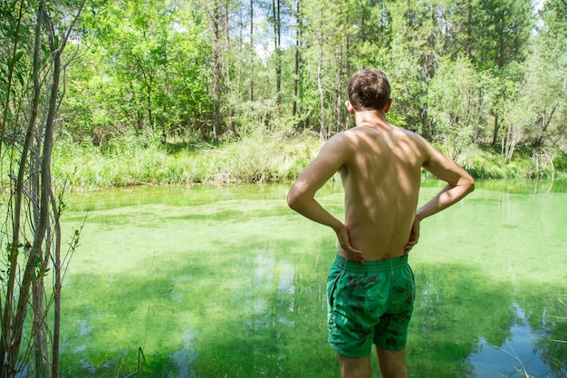 Young man in bathing clothes in the river