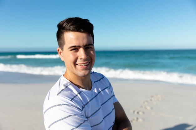 Young man at beach looking happy