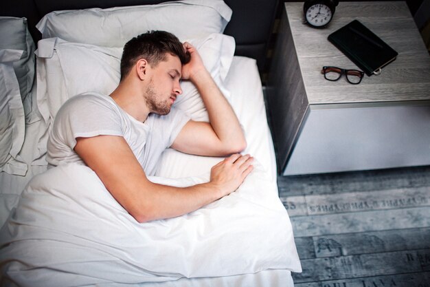 Young man in bed in the morning