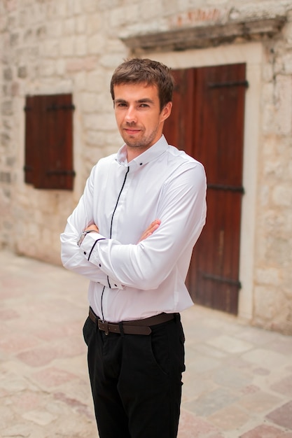 Young man in black pants and a white shirt