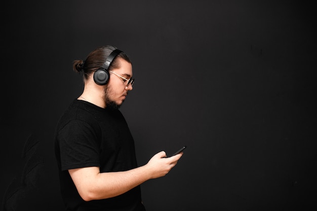 Young man on a black wall