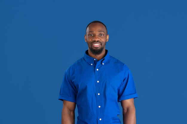 Young man on blue studio wall