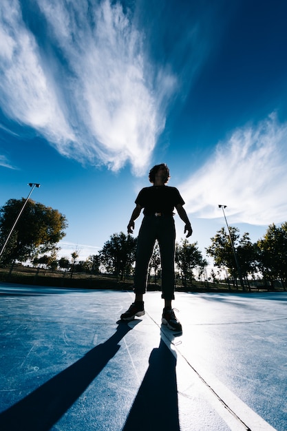 Young man break dancing at basketball court