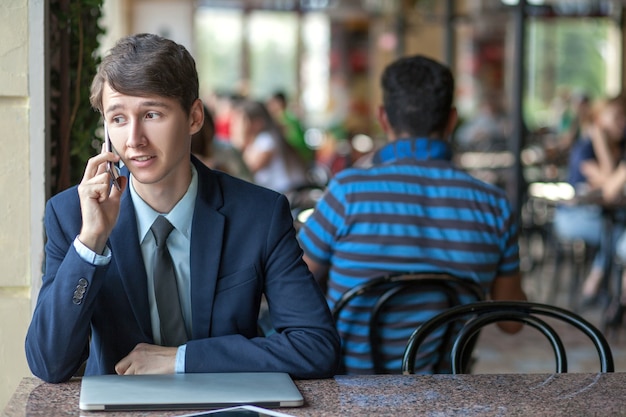 Young man in business suit sitting in office