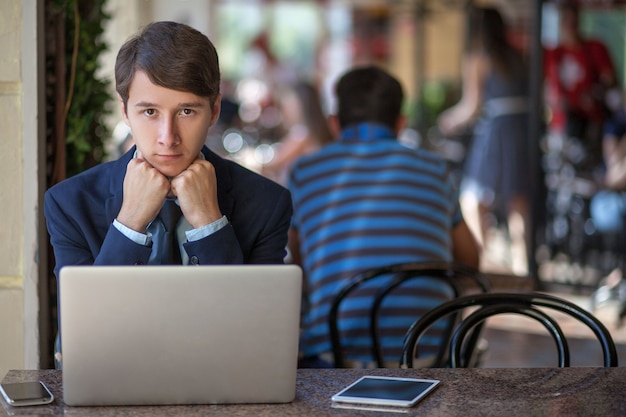 Young man in business suit sitting in office