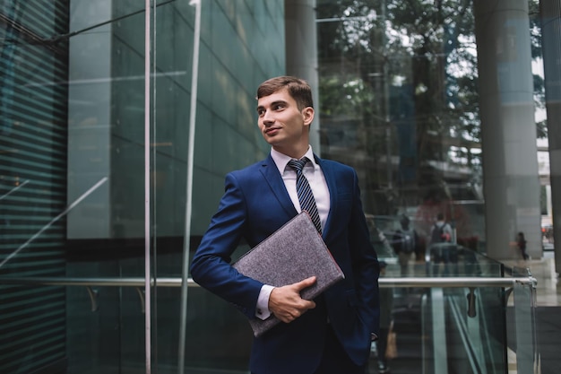 Young man in business suit with folder