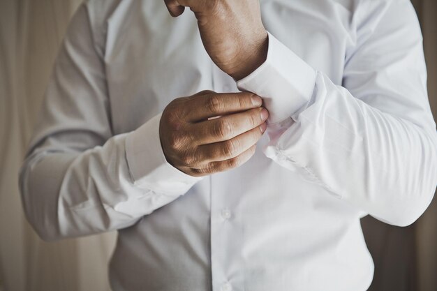 Young man buttons and a buttoned shirt sleeve 6808