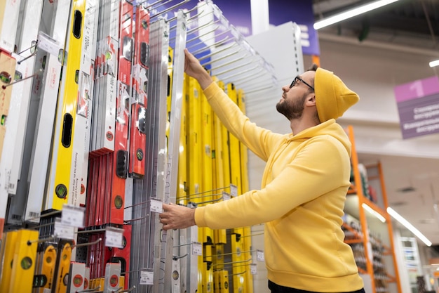 Young man buys a building bubble level