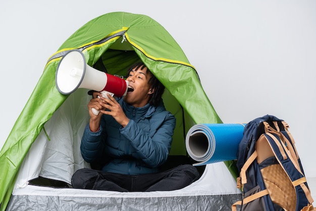 Young man in a camping tent