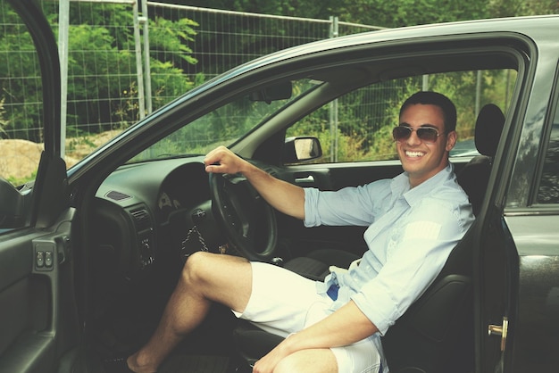 young man car driver changing clothes in car