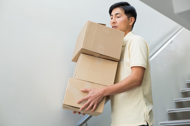 Young man carrying boxes